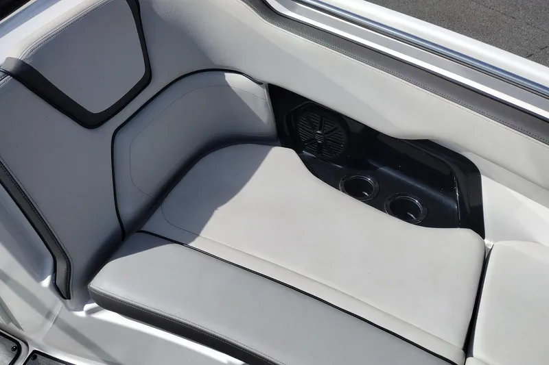 Slide: The Image of 2023 Yamaha AR250 boat interior seating with cup holders and speaker. - 32