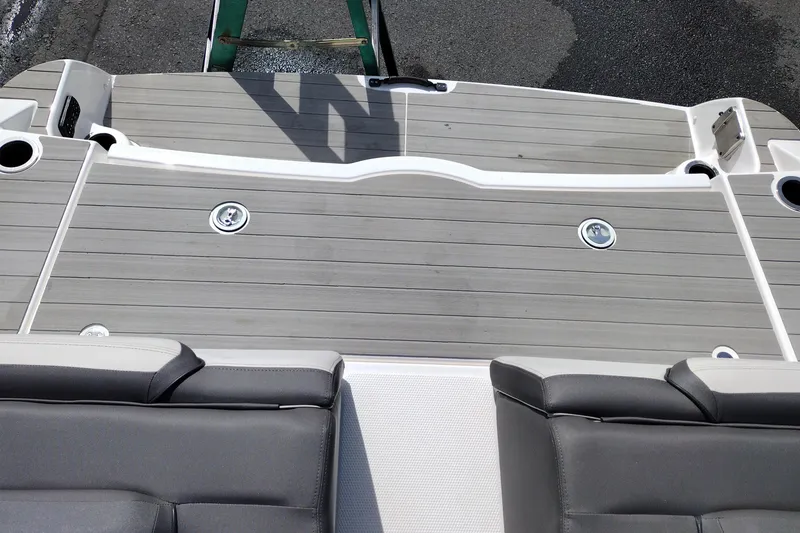 Slide: The Image of 2023 Yamaha AR250 boat deck with gray seating and sleek design. - 33