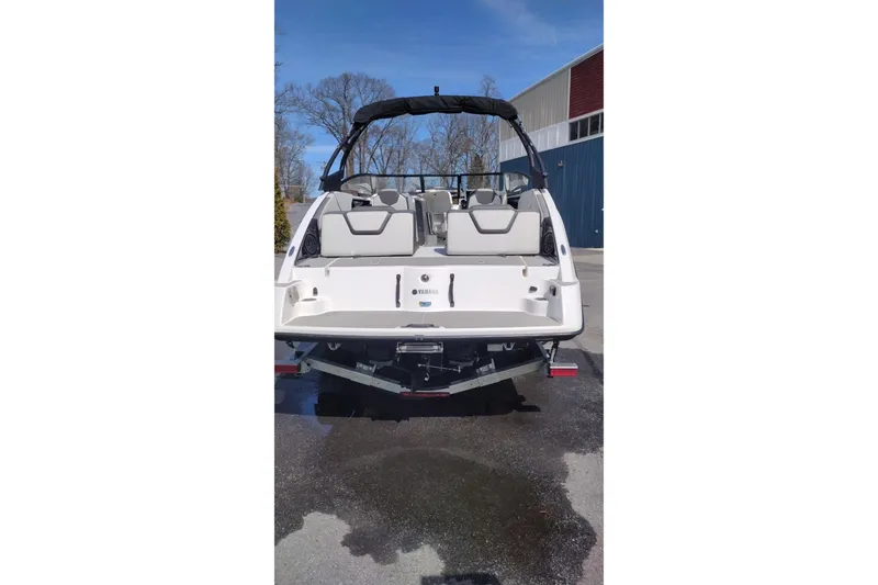 Slide: The Image of 2023 Yamaha AR250 boat rear view, showcasing seating and swim platform. - 7