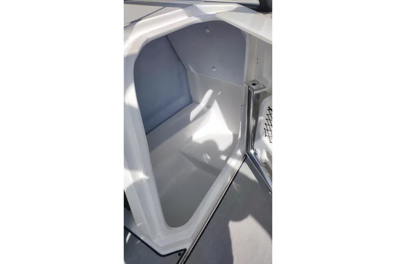 Slide: The Image of 2023 Yamaha AR250 boat storage compartment, open and empty, with sleek white interior. - 9