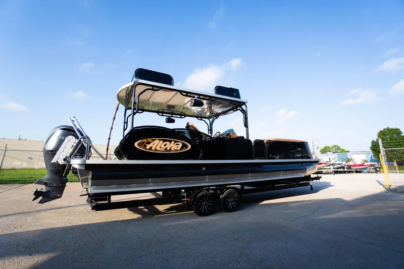 Slide: The Image of 2026 Aloha Paradise 300 Sundeck boat on trailer under clear blue sky. - 10