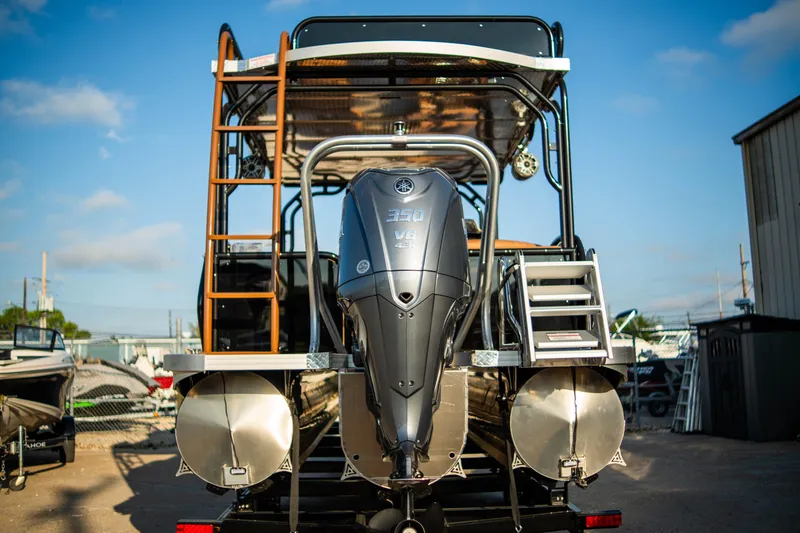 Slide: The Image of Aloha Paradise 300 Sundeck 2026 with powerful outboard motor, rear view. - 7