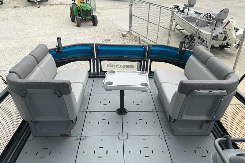 Slide: The Image of 2023 Sea-Doo Switch 19 interior with gray seating and table, outdoor setting. - 10