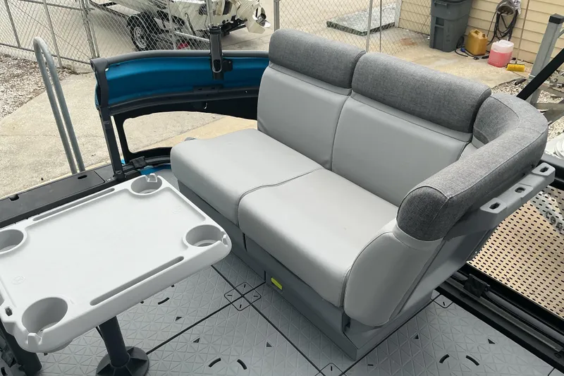 Slide: The Image of 2023 Sea-Doo Switch 19 interior with gray seating and a white table. - 11