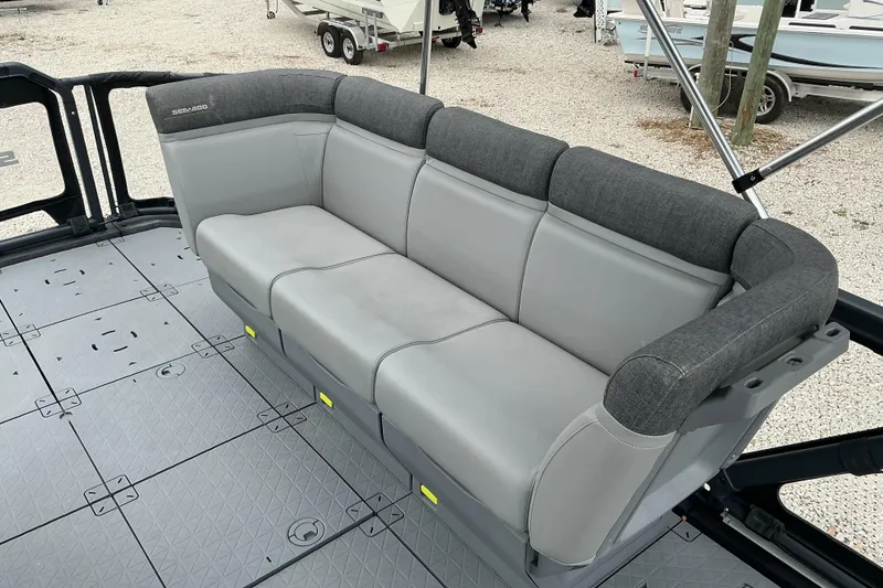 Slide: The Image of 2023 Sea-Doo Switch 19 boat interior with gray cushioned seating. - 7