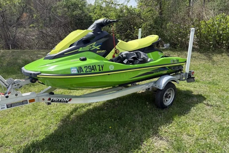 The Image of 2021 Yamaha WaveRunner EX Sport on trailer, vibrant green, parked on grass. - 0