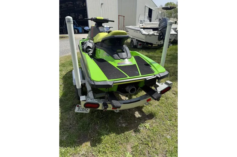 Slide: The Image of 2021 Yamaha WaveRunner EX Sport in vibrant green on a trailer, parked outdoors. - 2