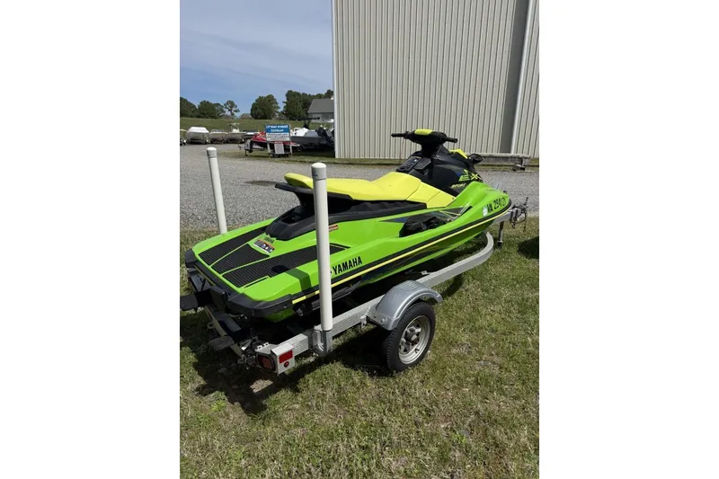 Slide: The Image of 2021 Yamaha WaveRunner EX Sport in vibrant green on a trailer, parked outdoors. - 3