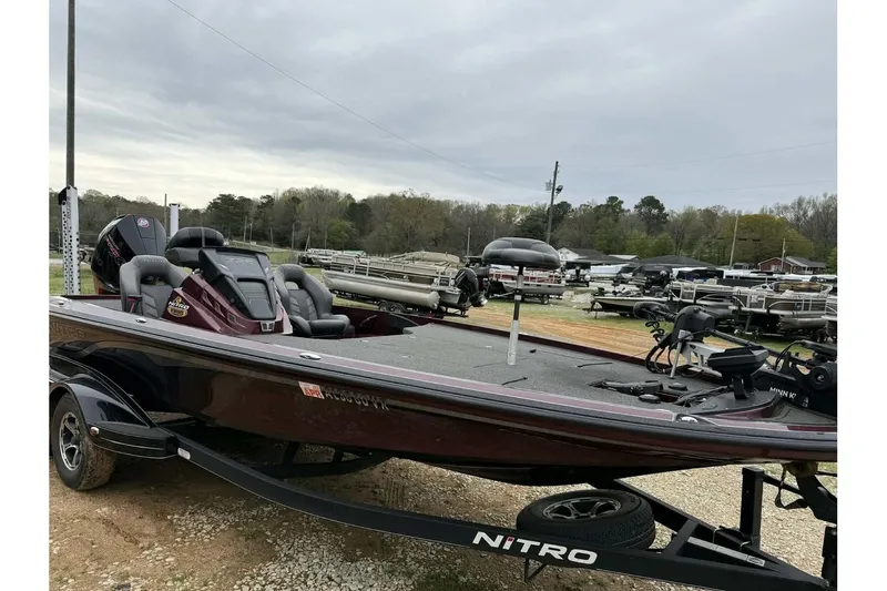 Slide: The Image of 2022 Nitro Z20 Pro bass boat on trailer, parked outdoors. - 1