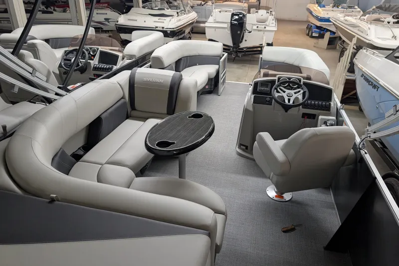 Slide: The Image of Interior of 2026 Sylvan Mirage 820 Cruise pontoon boat with plush seating and modern helm. - 9
