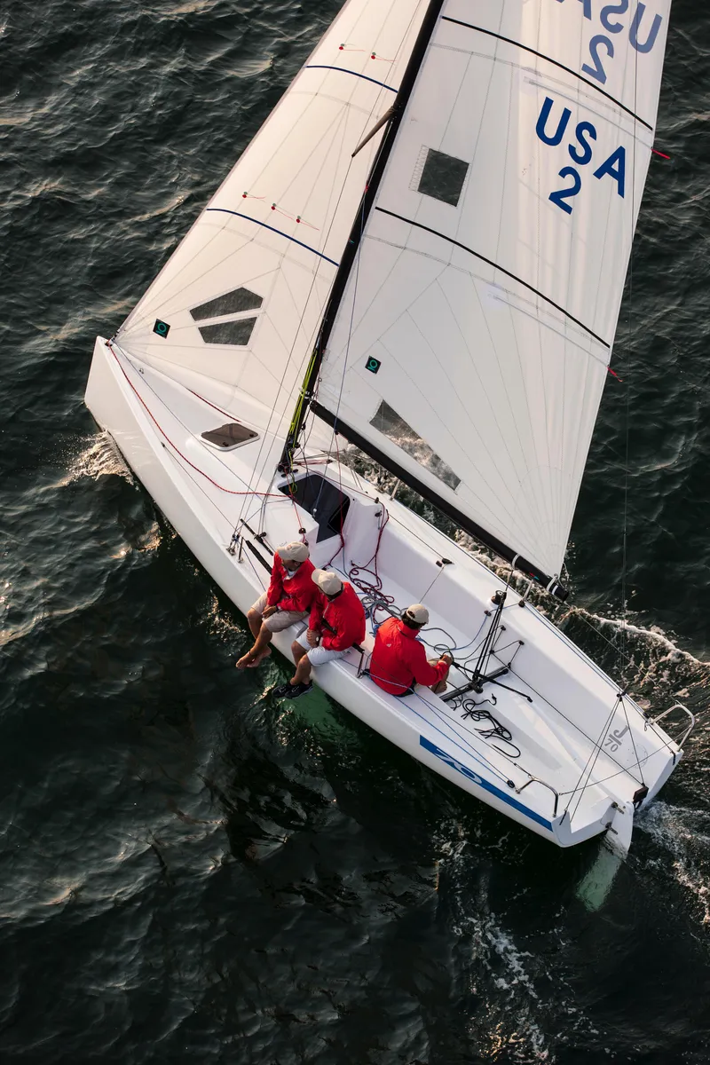 Slide: The Image of 2013 J Boats J/70 sailboat under blue tarp, showing deck and hatch. - 9