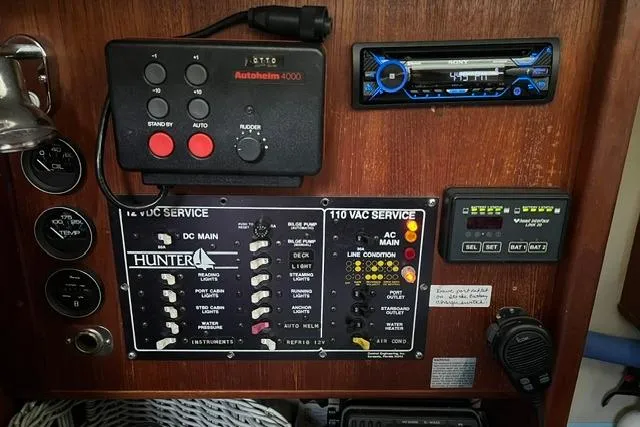 Slide: The Image of Control panel of a 1990 Hunter 33.5 sailboat with various switches and devices. - 10
