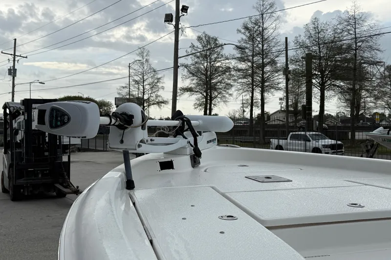Slide: The Image of 2015 Blue Wave 2000 PureBay boat with trolling motor, parked outdoors. - 11