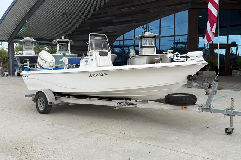 Slide: The Image of 2015 Blue Wave 2000 PureBay boat on trailer, parked outside a showroom. - 2