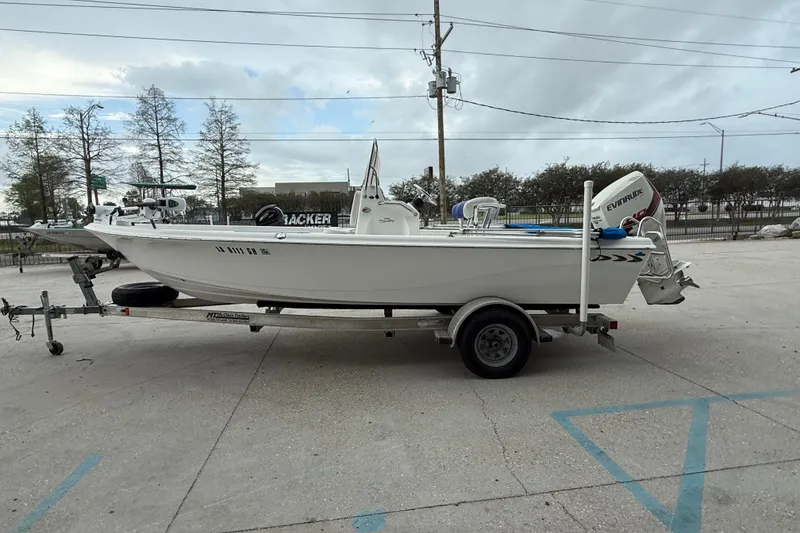 Slide: The Image of 2015 Blue Wave 2000 PureBay boat on trailer, parked outdoors. - 6