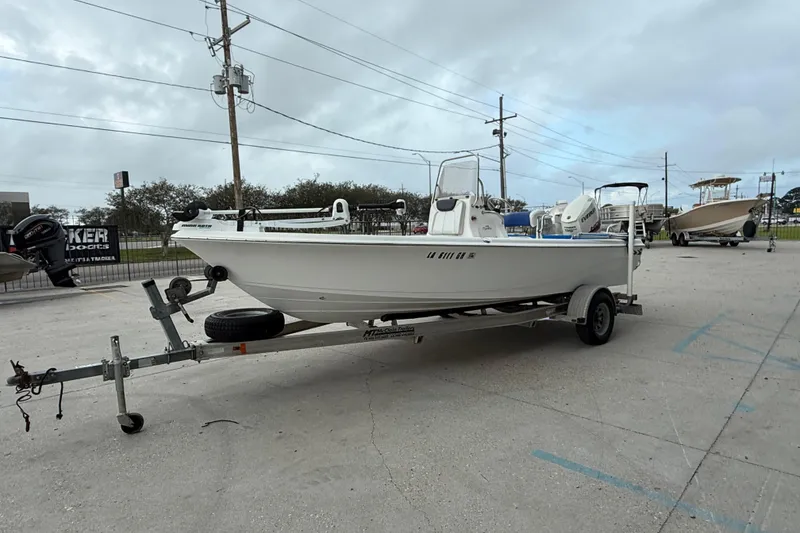 Slide: The Image of 2015 Blue Wave 2000 PureBay boat on trailer in parking lot, overcast sky. - 7