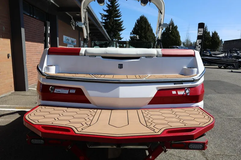 Slide: The Image of 2021 MasterCraft NXT24 boat rear view with teak-style swim platform. - 11