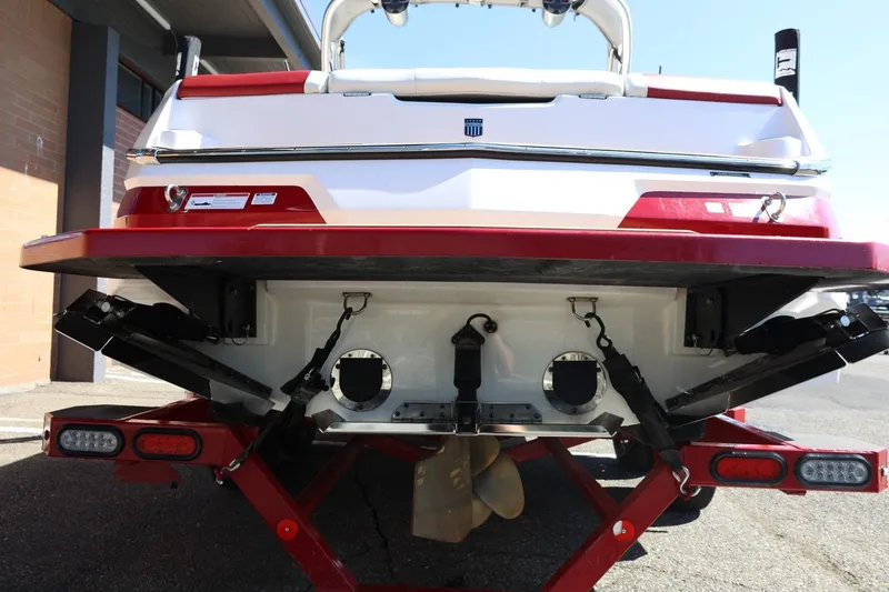 Slide: The Image of 2021 MasterCraft NXT24 boat rear view with red and white detailing. - 12