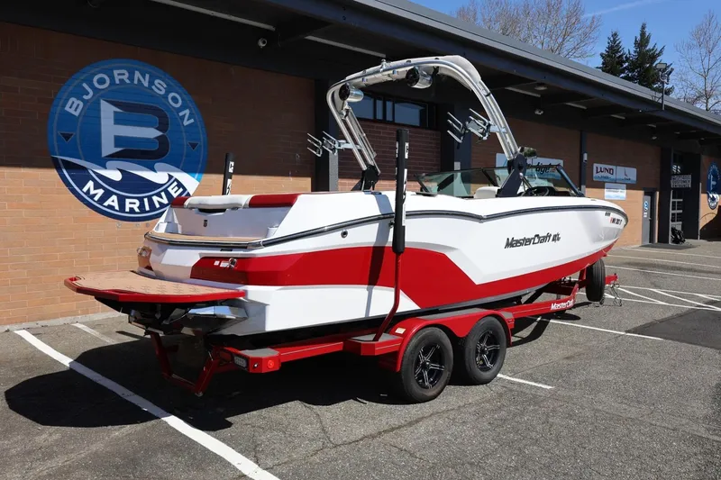 Slide: The Image of 2021 MasterCraft NXT24 boat in red and white at Bjornson Marine dealership. - 14