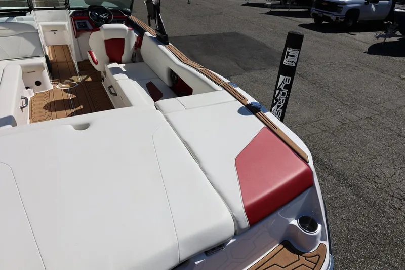 Slide: The Image of 2021 MasterCraft NXT24 boat interior with white and red seating, wood accents. - 20