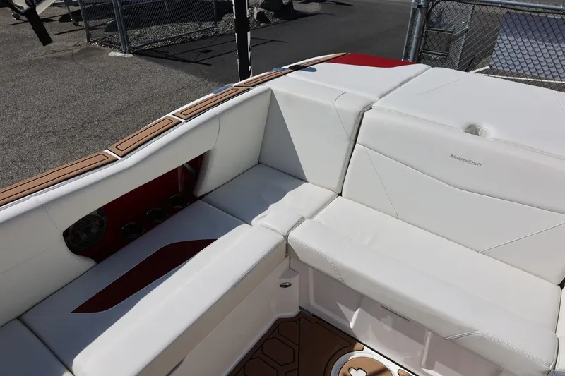 Slide: The Image of 2021 MasterCraft NXT24 boat interior with white seating and wood accents. - 26