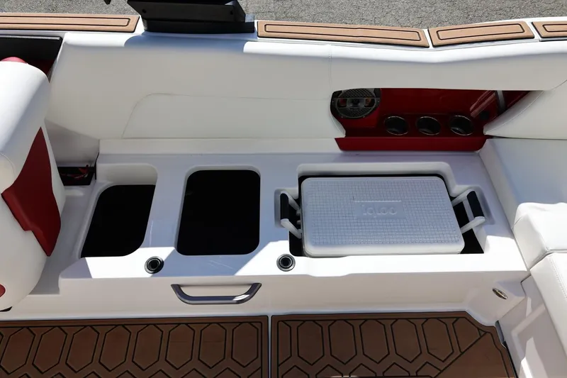 Slide: The Image of 2021 MasterCraft NXT24 boat interior with storage compartments and cooler. - 27