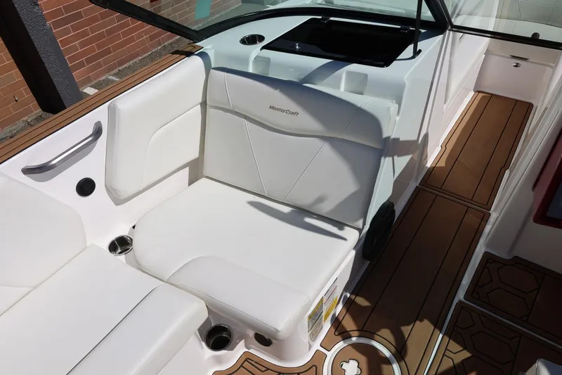 Slide: The Image of 2021 MasterCraft NXT24 boat interior with white seating and teak-style flooring. - 36