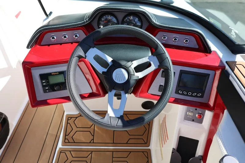 Slide: The Image of 2021 MasterCraft NXT24 boat dashboard with steering wheel and control panel. - 39