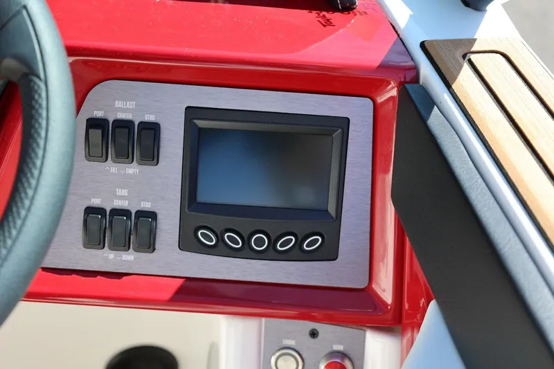 Slide: The Image of 2021 MasterCraft NXT24 boat dashboard with control panel and display screen. - 40