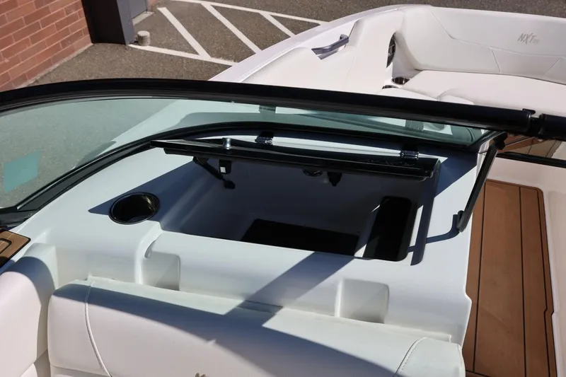 Slide: The Image of 2021 MasterCraft NXT24 boat interior with open storage compartment and seating area. - 45