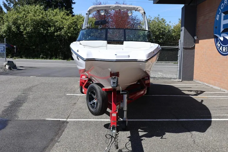 Slide: The Image of 2021 MasterCraft NXT24 boat on trailer in parking lot, front view. - 5
