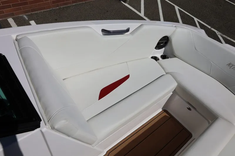 Slide: The Image of 2021 MasterCraft NXT24 boat interior with white seating and red accent. - 51