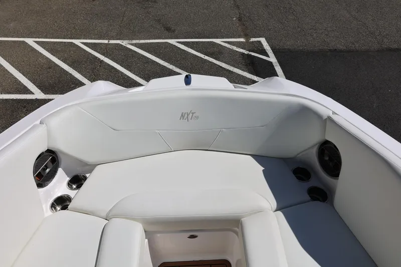 Slide: The Image of 2021 MasterCraft NXT24 boat interior with white seating and cup holders. - 53