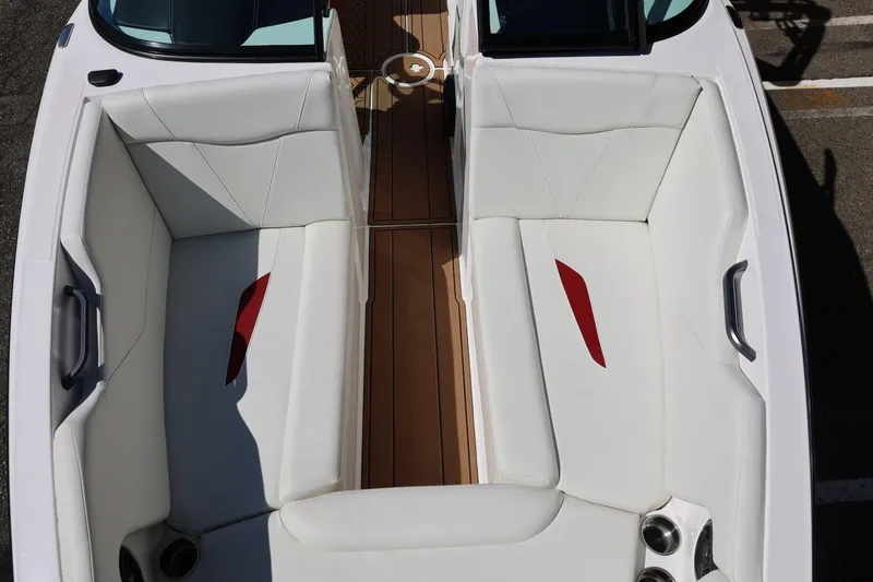 Slide: The Image of 2021 MasterCraft NXT24 boat interior with white seating and red accents. - 54
