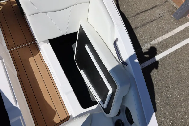 Slide: The Image of 2021 MasterCraft NXT24 boat interior with open storage compartment and teak flooring. - 55