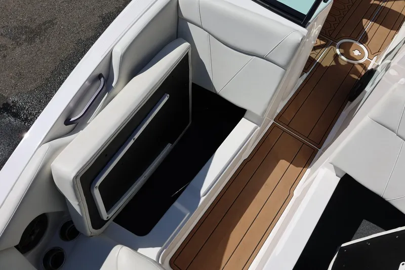 Slide: The Image of 2021 MasterCraft NXT24 boat interior with white seating and teak-style flooring. - 56