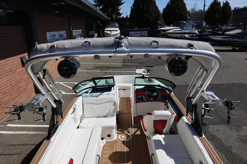 Slide: The Image of 2021 MasterCraft NXT24 boat interior with seating, steering wheel, and wakeboard tower. - 60