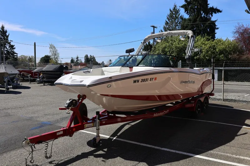 Slide: The Image of 2021 MasterCraft NXT24 boat on trailer in parking lot, sunny day. - 7