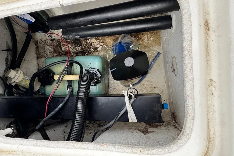 Slide: The Image of 2010 Triton 240 LTS Pro boat compartment with wiring and equipment. - 10