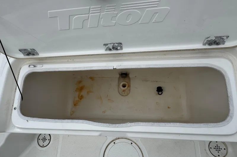 Slide: The Image of Open storage compartment on a 2010 Triton 240 LTS Pro boat. - 11