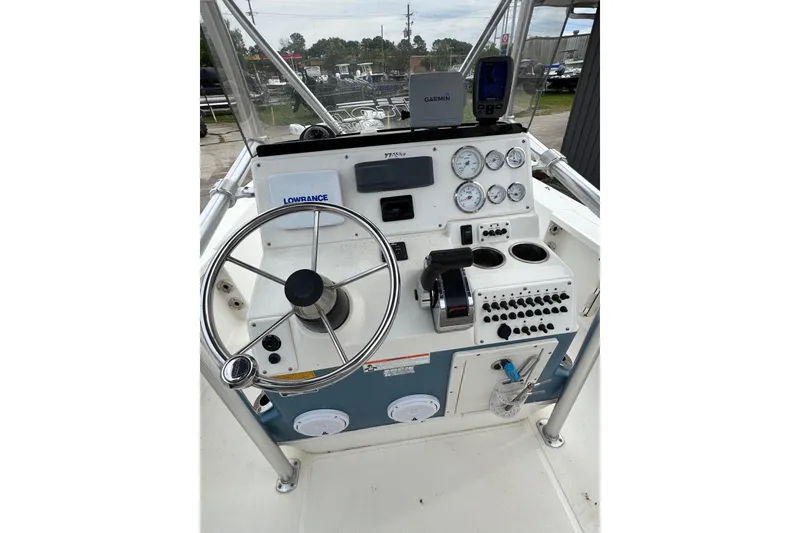 Slide: The Image of 2010 Triton 240 LTS Pro boat console with steering wheel, gauges, and navigation equipment. - 14
