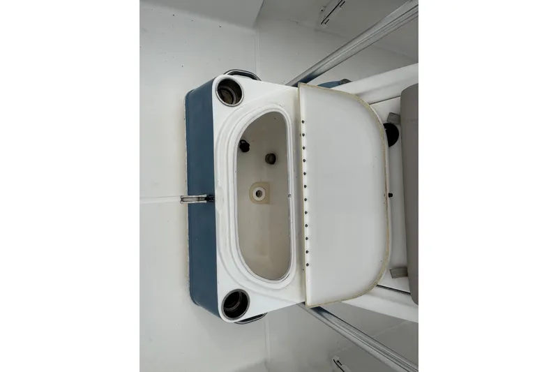 Slide: The Image of Livewell on a 2010 Triton 240 LTS Pro boat, featuring cup holders and open lid. - 20