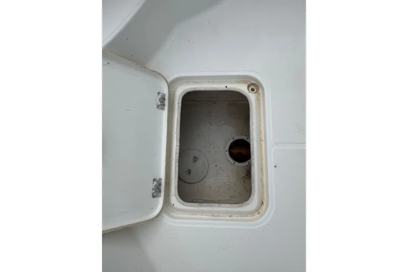 Slide: The Image of Open storage compartment on a 2010 Triton 240 LTS Pro boat. - 21
