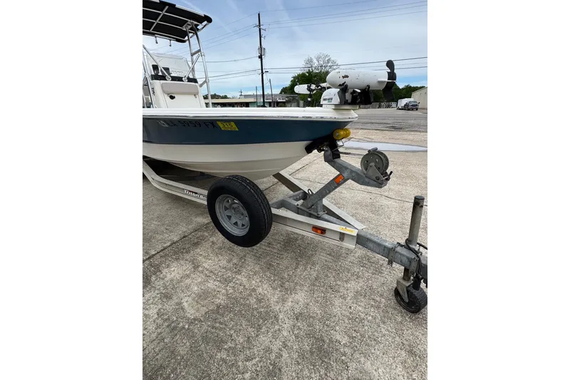 Slide: The Image of 2010 Triton 240 LTS Pro boat on trailer, parked on concrete surface. - 4