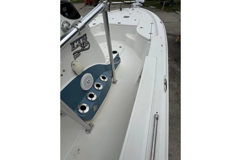 Slide: The Image of 2010 Triton 240 LTS Pro boat interior with rod holders and speaker. - 6