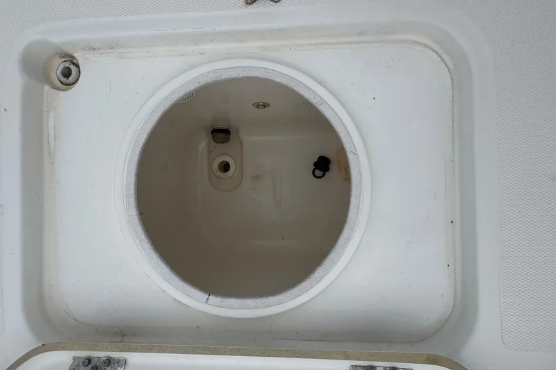 Slide: The Image of Livewell compartment on a 2010 Triton 240 LTS Pro boat, featuring a circular design. - 9