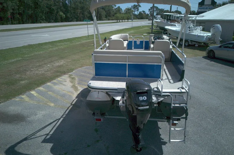 Slide: The Image of 2024 Lowe Ultra 200 Cruise pontoon boat with Mercury 90 engine, parked outdoors. - 11