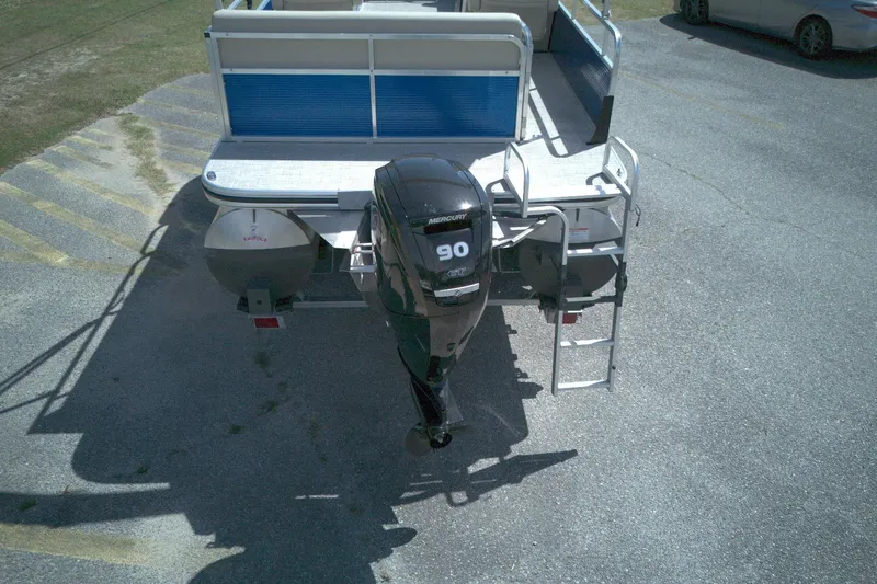 Slide: The Image of 2024 Lowe Ultra 200 Cruise pontoon boat with Mercury 90 engine, parked on pavement. - 3