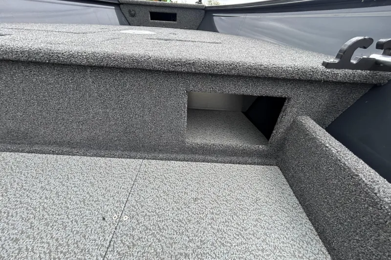 Slide: The Image of 2026 Crestliner 1650 Discovery Tiller boat interior with textured flooring and storage compartment. - 11