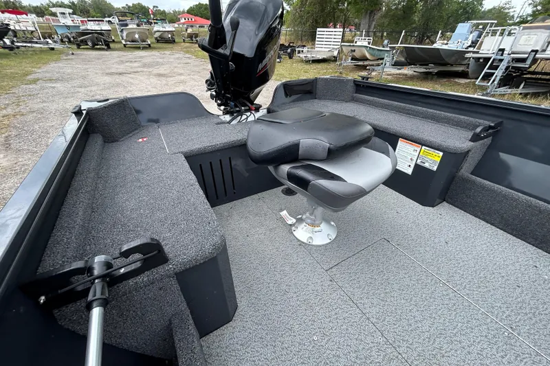 Slide: The Image of 2026 Crestliner 1650 Discovery Tiller boat interior with seating and motor. - 12